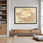 a large framed map of the Arctic region hanging on a wall in a room with a wooden bookshelf and a wooden table.