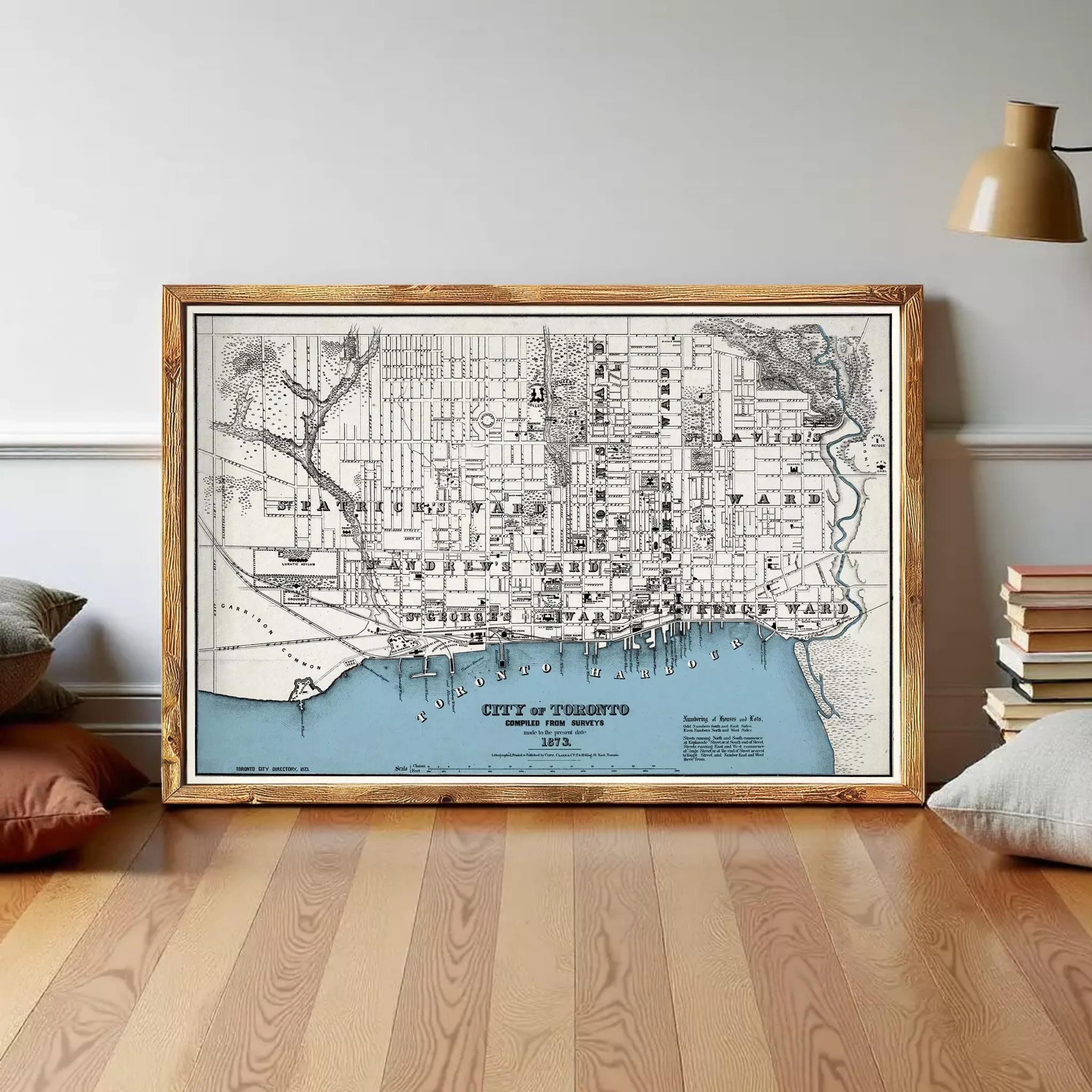 The image is a framed map of Toronto, Canada, depicting the city's streets and surrounding areas.
