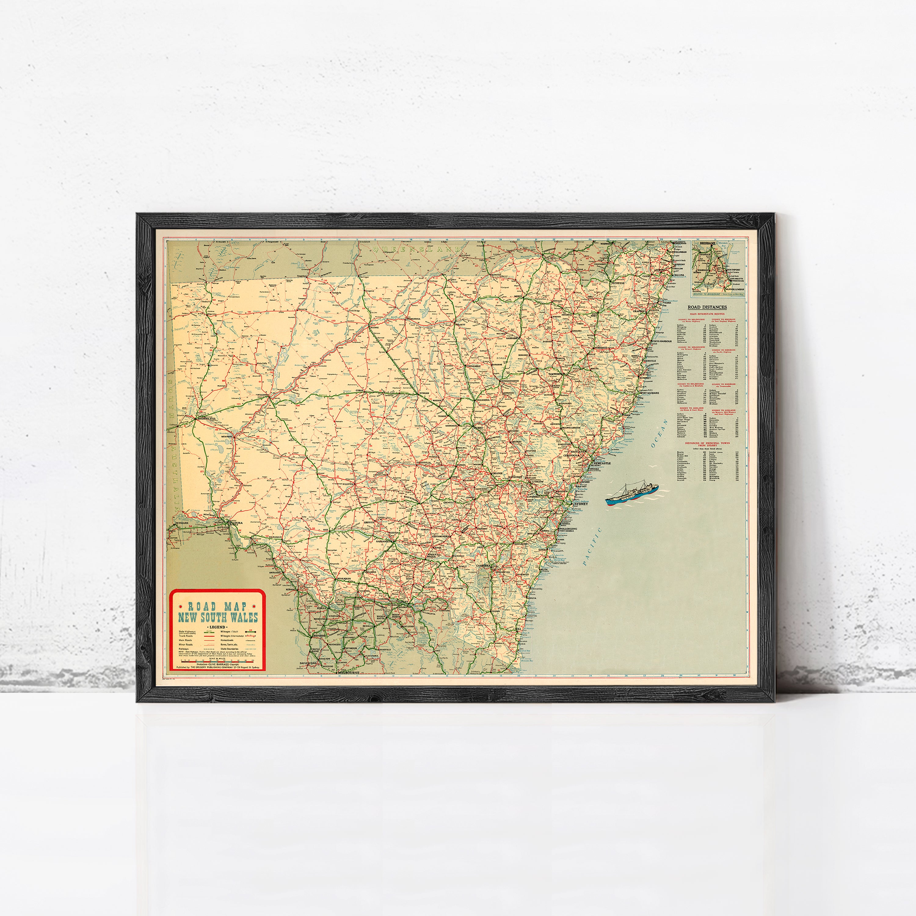 The image is a framed vintage road map of the United States, showing the major highways and cities in a detailed and colorful manner.