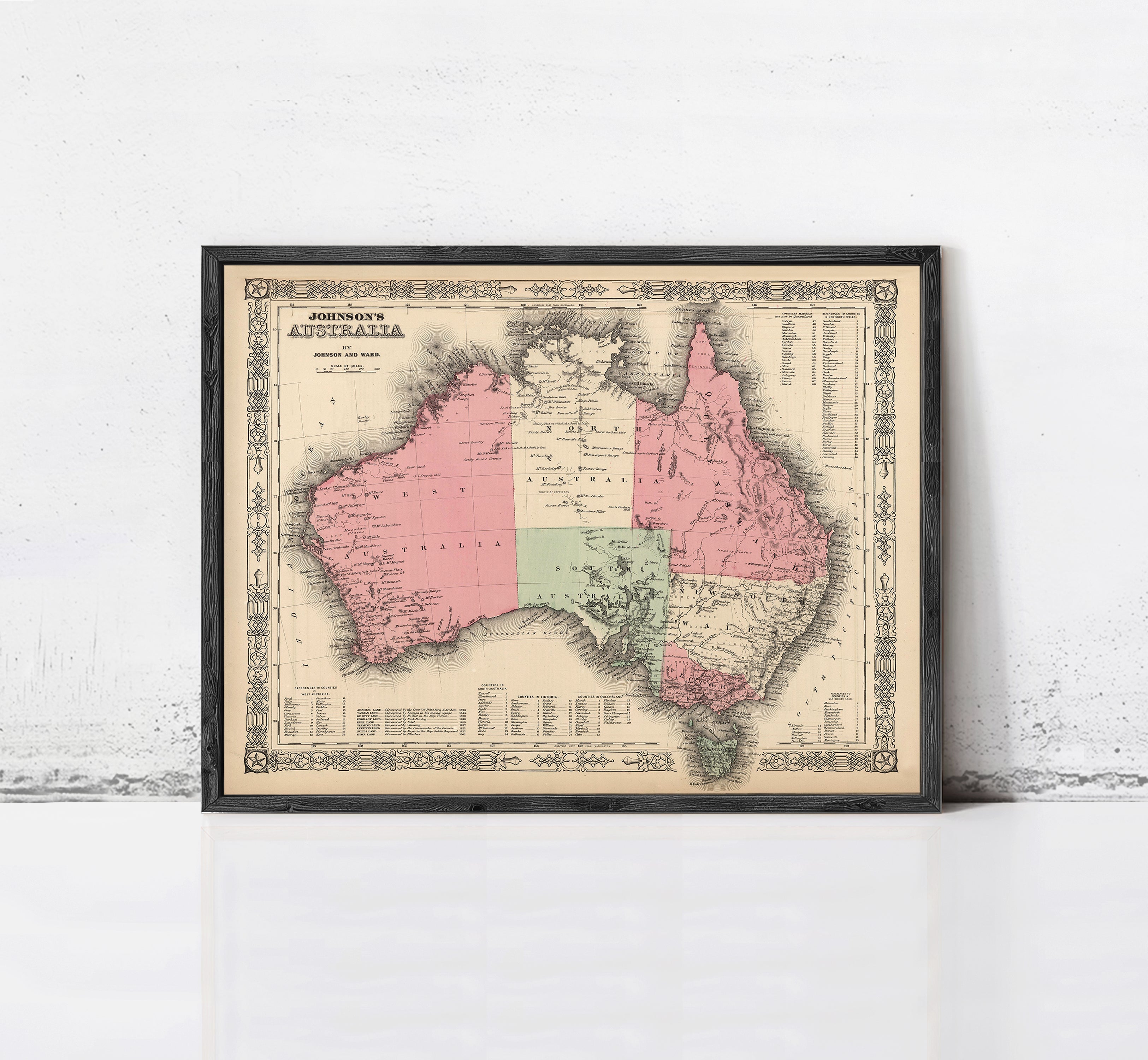The image is a framed vintage map of Australia, depicting the country in a detailed and intricate manner.