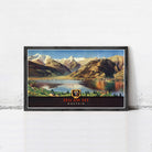 A framed vintage poster depicting a scenic mountain landscape with a lake and a town in the foreground, with the text "ZELL AM SEE AUSTRIA" prominently displayed.