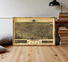 The image is a framed vintage map of a city, likely from the early 20th century, depicting a densely populated urban area with various landmarks and streets.