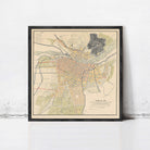 The image is a framed map of a city, depicting various streets, landmarks, and geographical features.