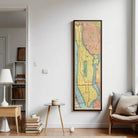 a large framed map of New York City hanging on a white wall in a living room.
