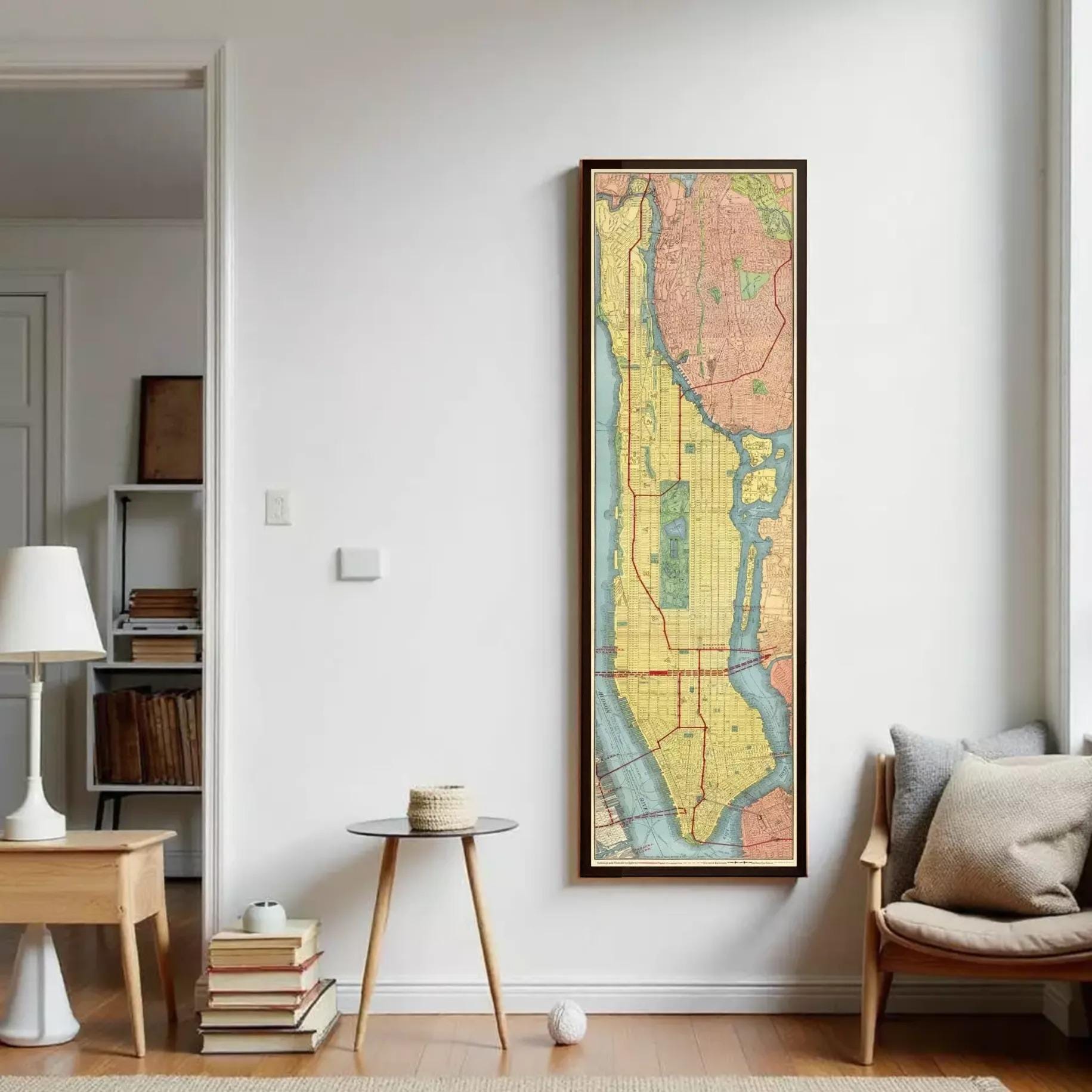 a large framed map of New York City hanging on a white wall in a living room.