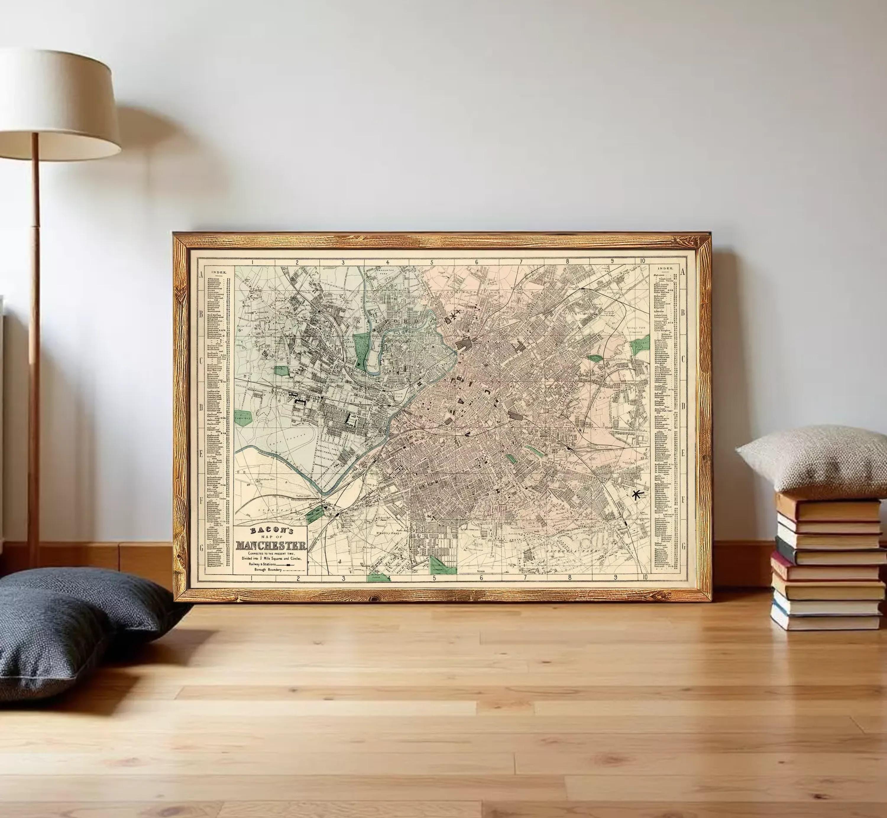 The image is a framed vintage map of a city, likely from the early 20th century, displayed on a white wall.