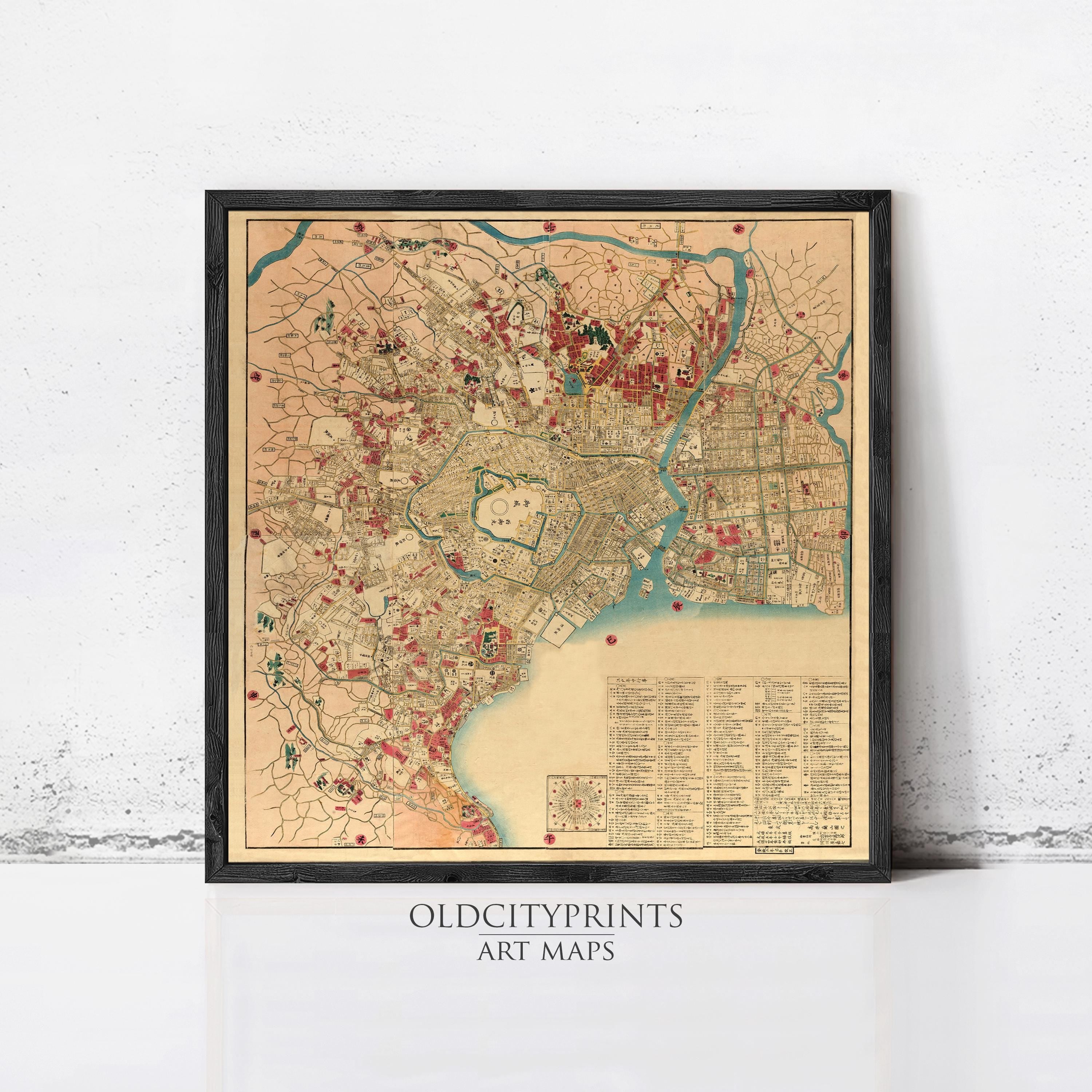 The image is a framed vintage map of a city, likely from the 19th century, with various landmarks and streets depicted in a detailed manner.