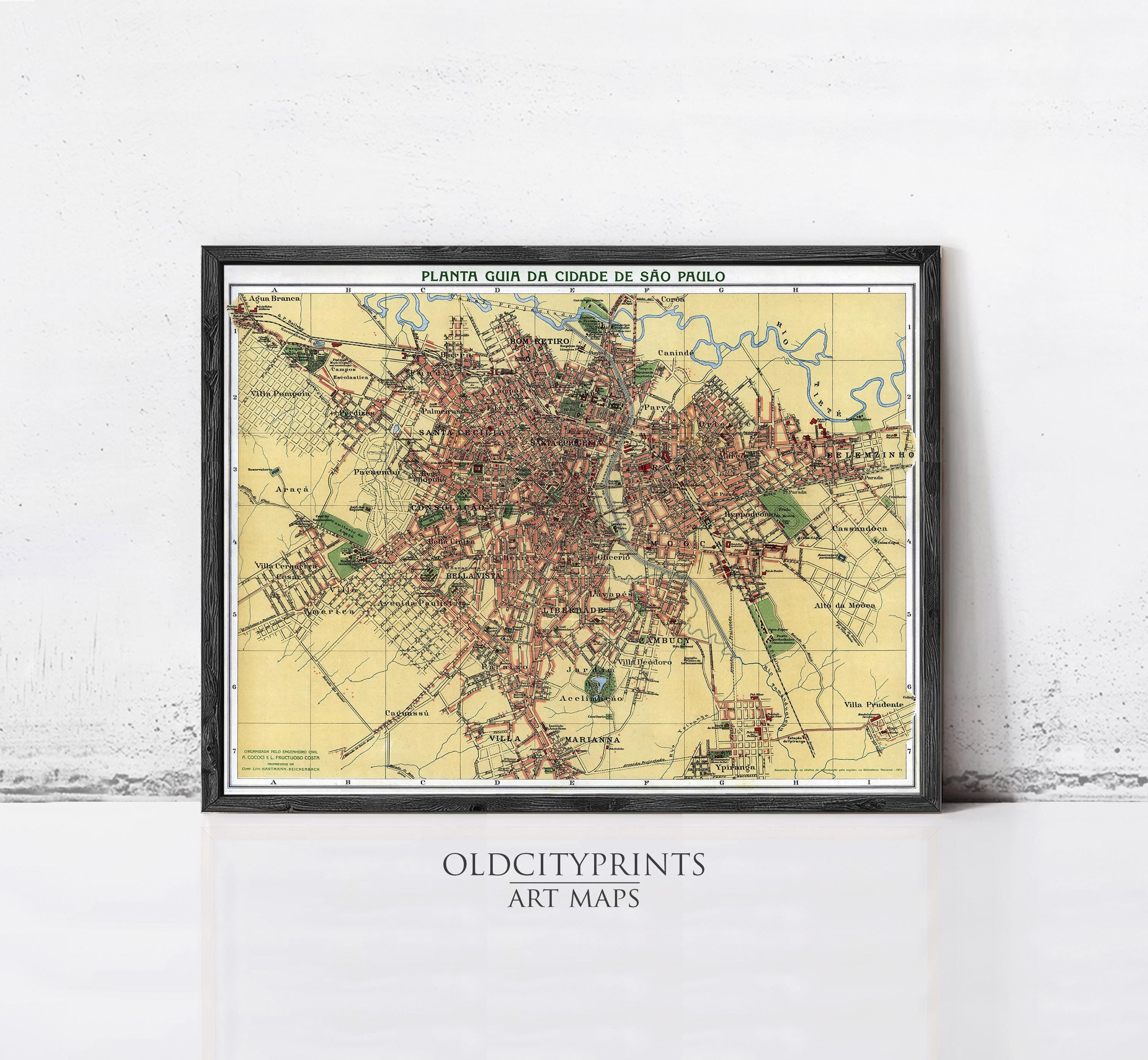 The image is a framed vintage map of a city, likely from the early 20th century, with a black border and a white background.