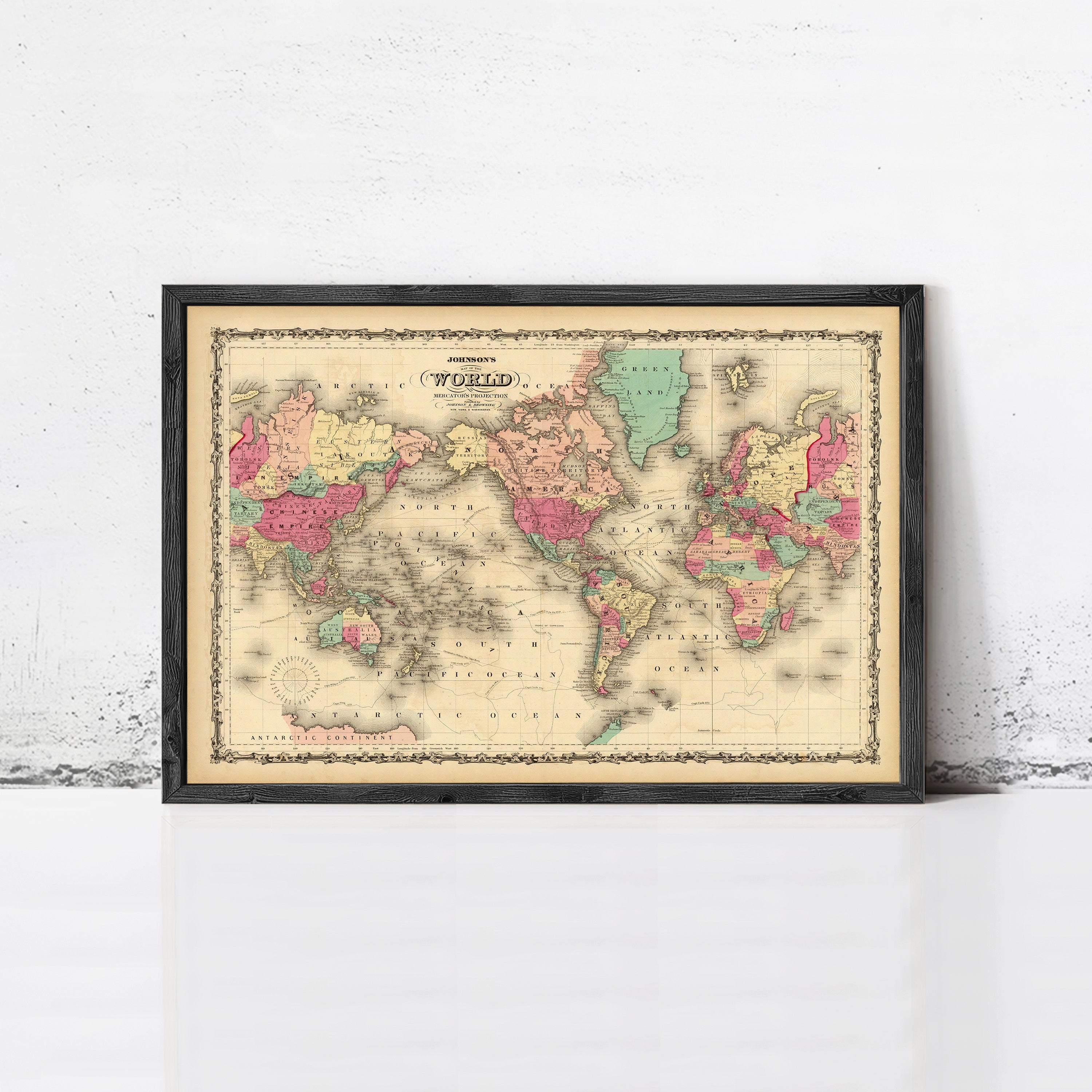 The image is a framed vintage map of the world, depicting the continents and oceans in a detailed and colorful manner.
