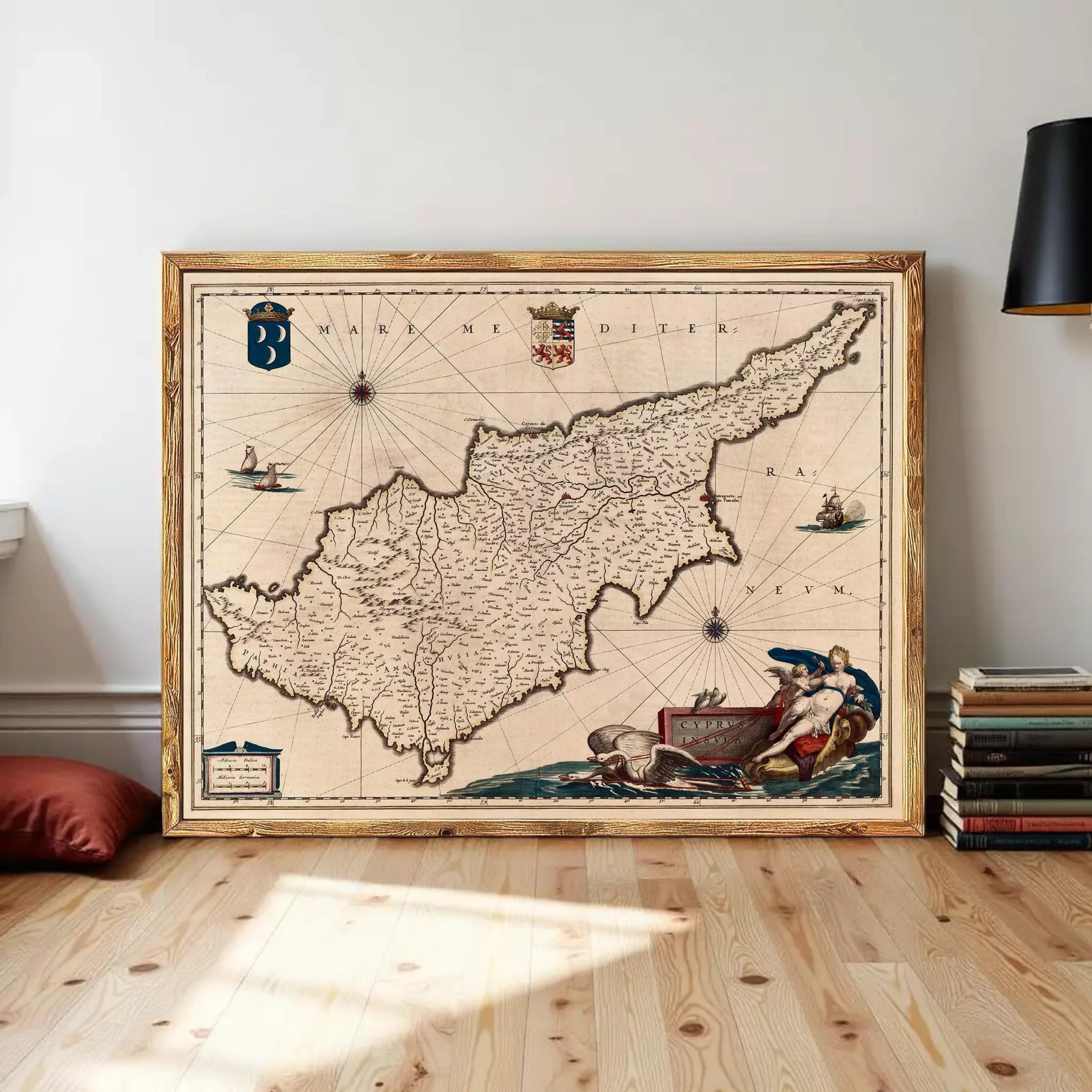 The image is a framed antique map of the island of Cyprus, featuring detailed cartography and maritime imagery.