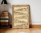 A framed vintage map depicting mountain ranges is leaning against a wall next to a stack of books.