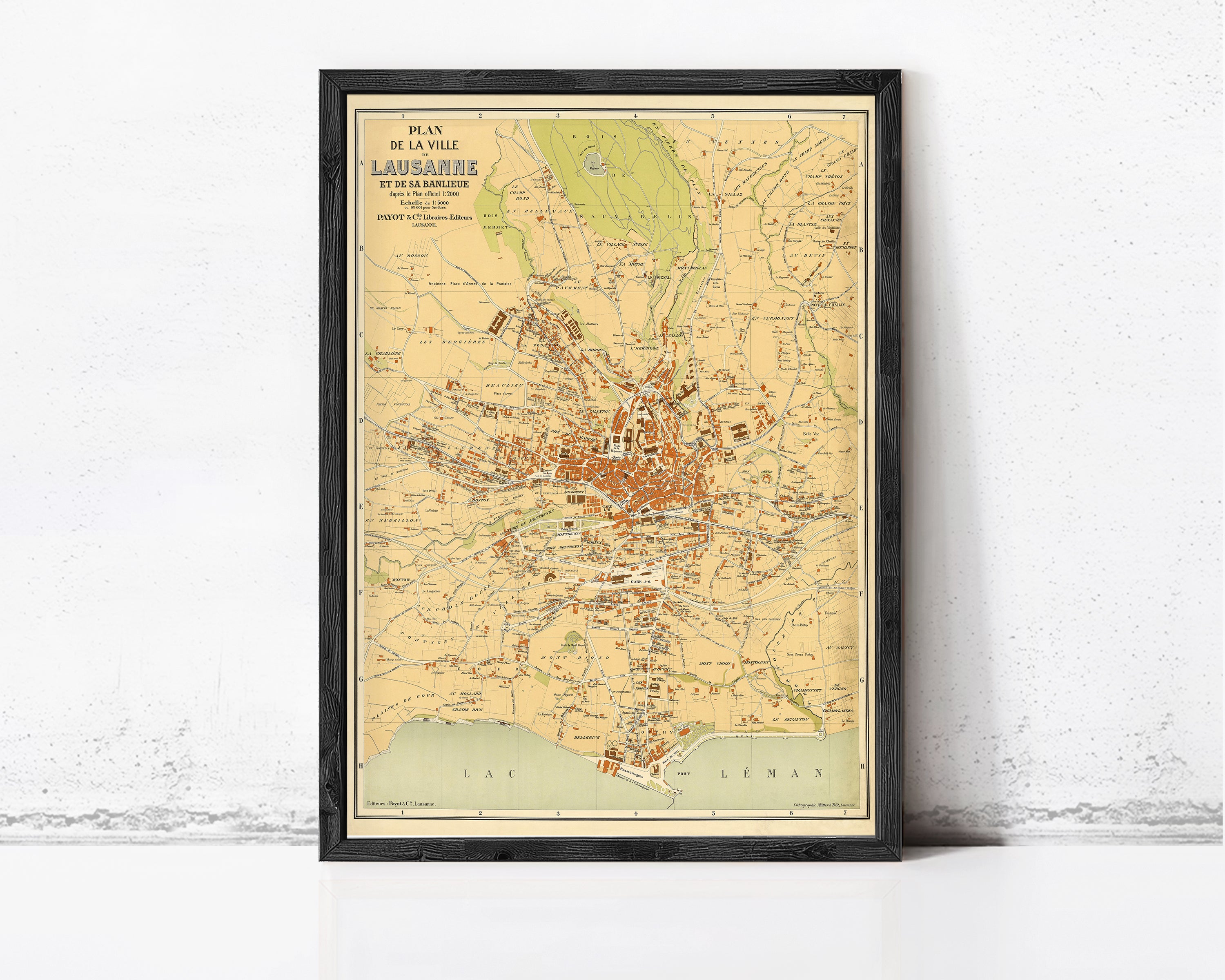The image is a framed vintage map of the city of Lausanne, Switzerland, depicting the city's layout and surrounding areas.