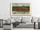 a large framed painting of a cityscape with boats in the foreground, hanging on a wall above a gray couch in a living room setting.