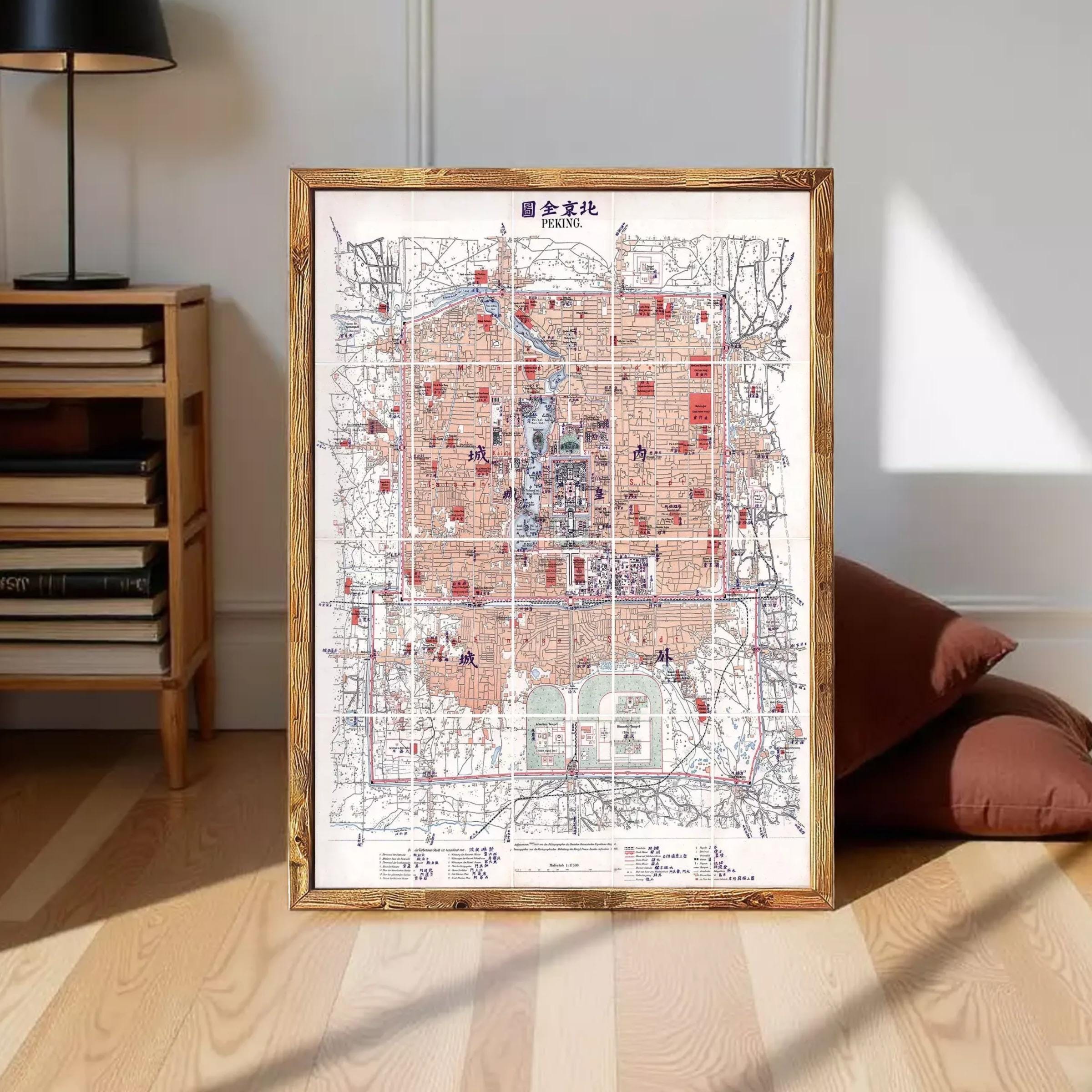 a large, detailed map of a city or region, with various landmarks and streets clearly marked. The map is framed and displayed on a wooden floor, with a lamp and some books visible in the background.