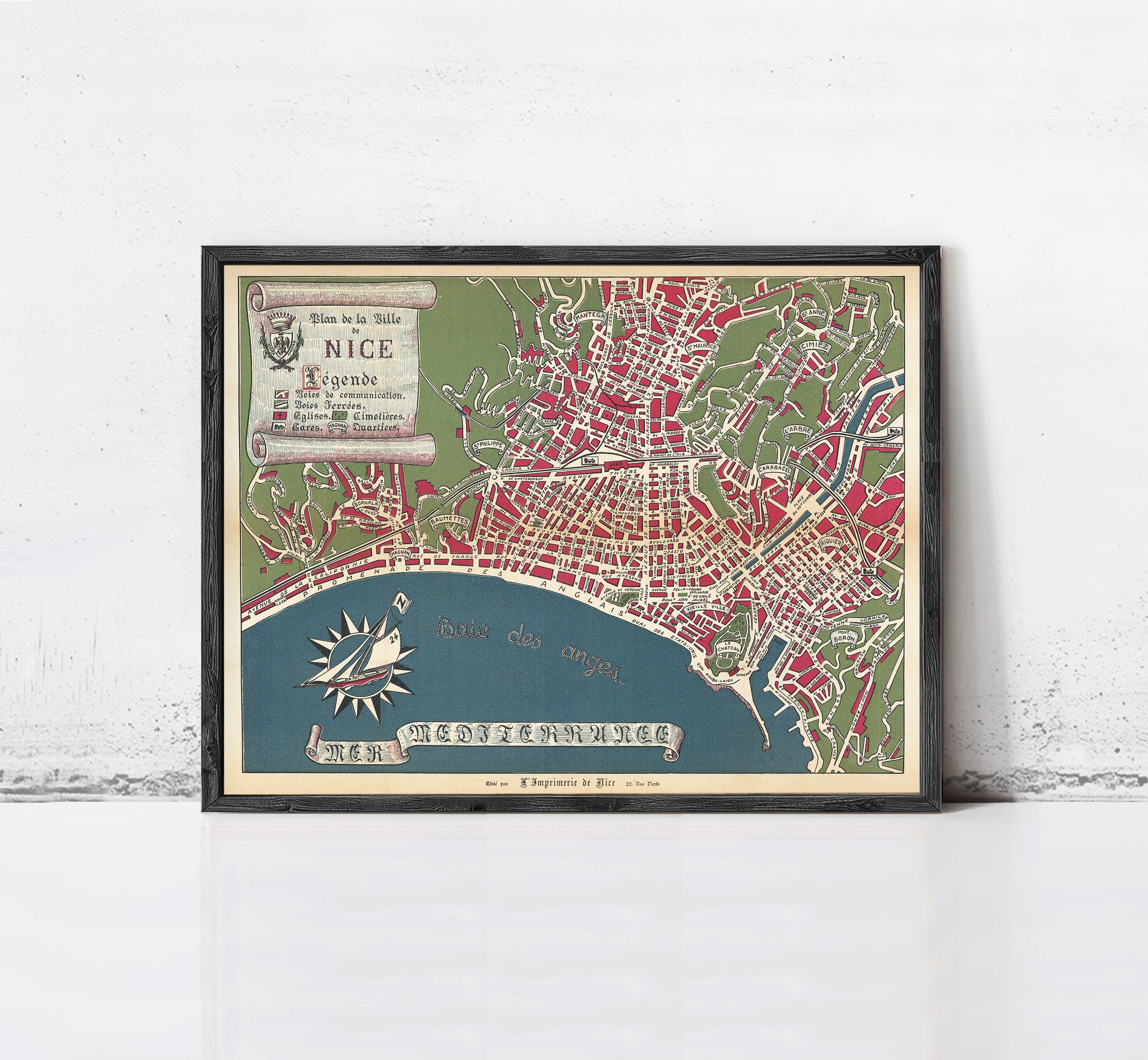 The image is a framed vintage map of Nice, France, depicting the city's layout and surrounding areas.