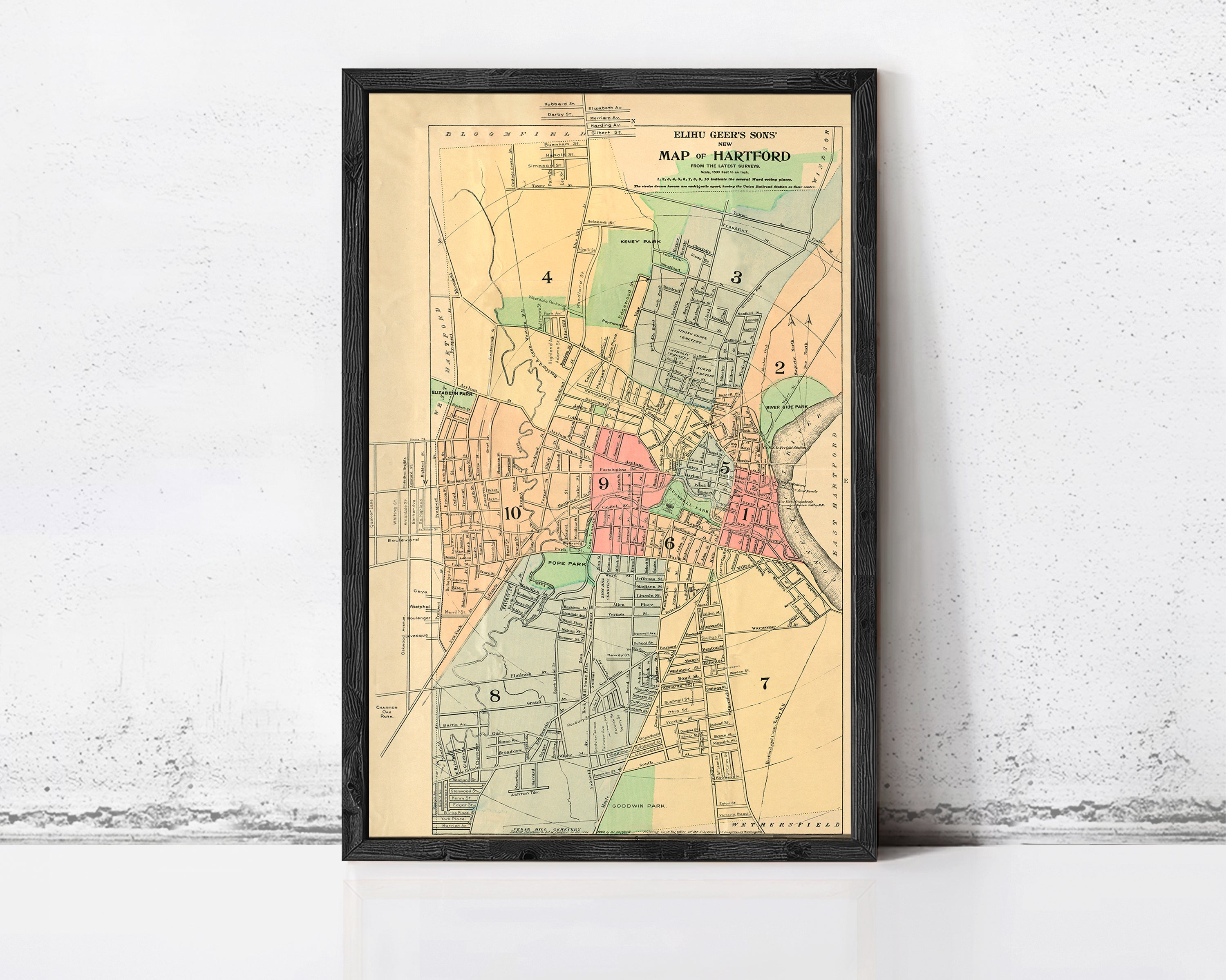 The image is a framed vintage map of the town of Hartford, Connecticut, showing the layout of the streets, neighborhoods, and other geographical features.