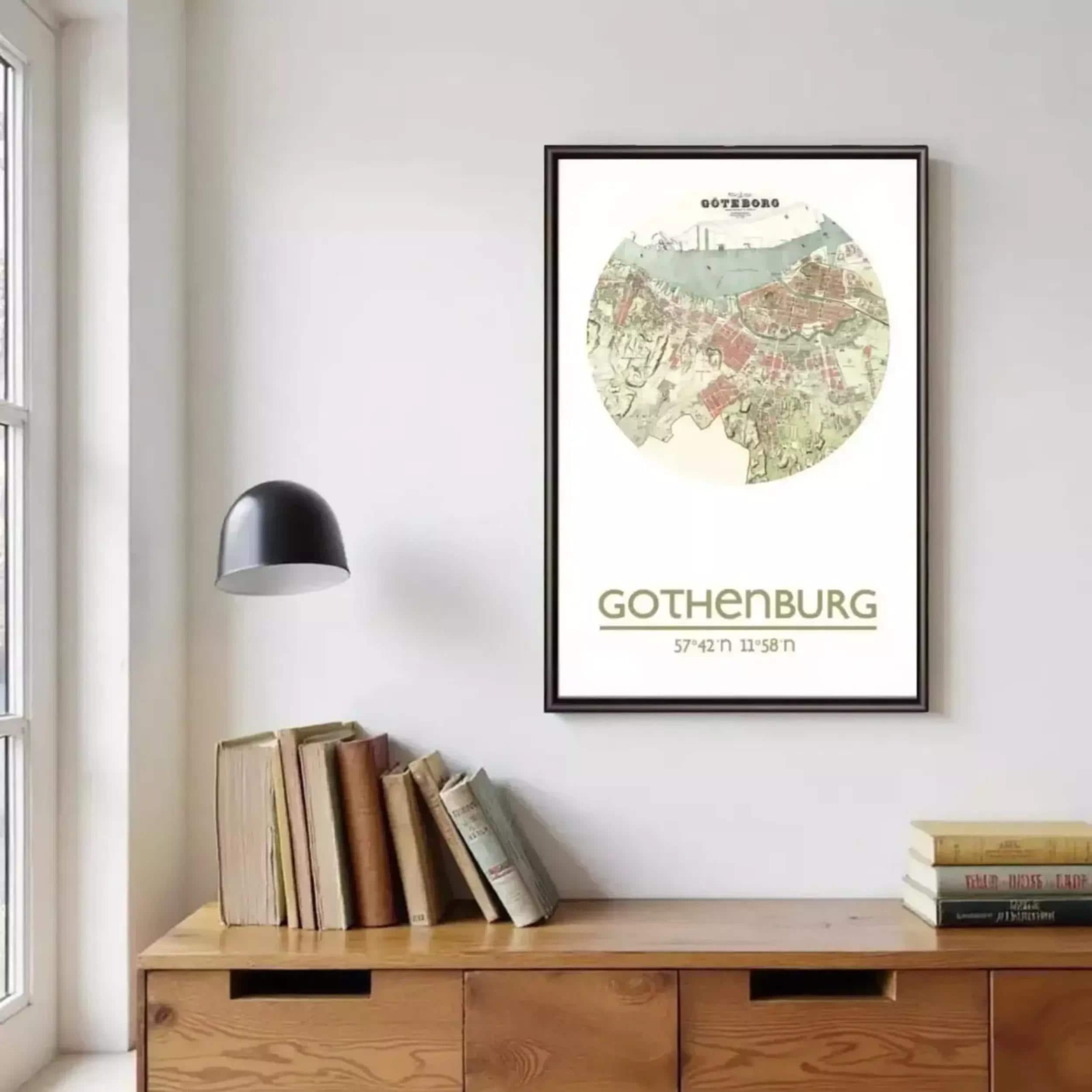 a framed map of Gothenburg, a city in Sweden, hanging on a wall above a wooden cabinet or dresser.