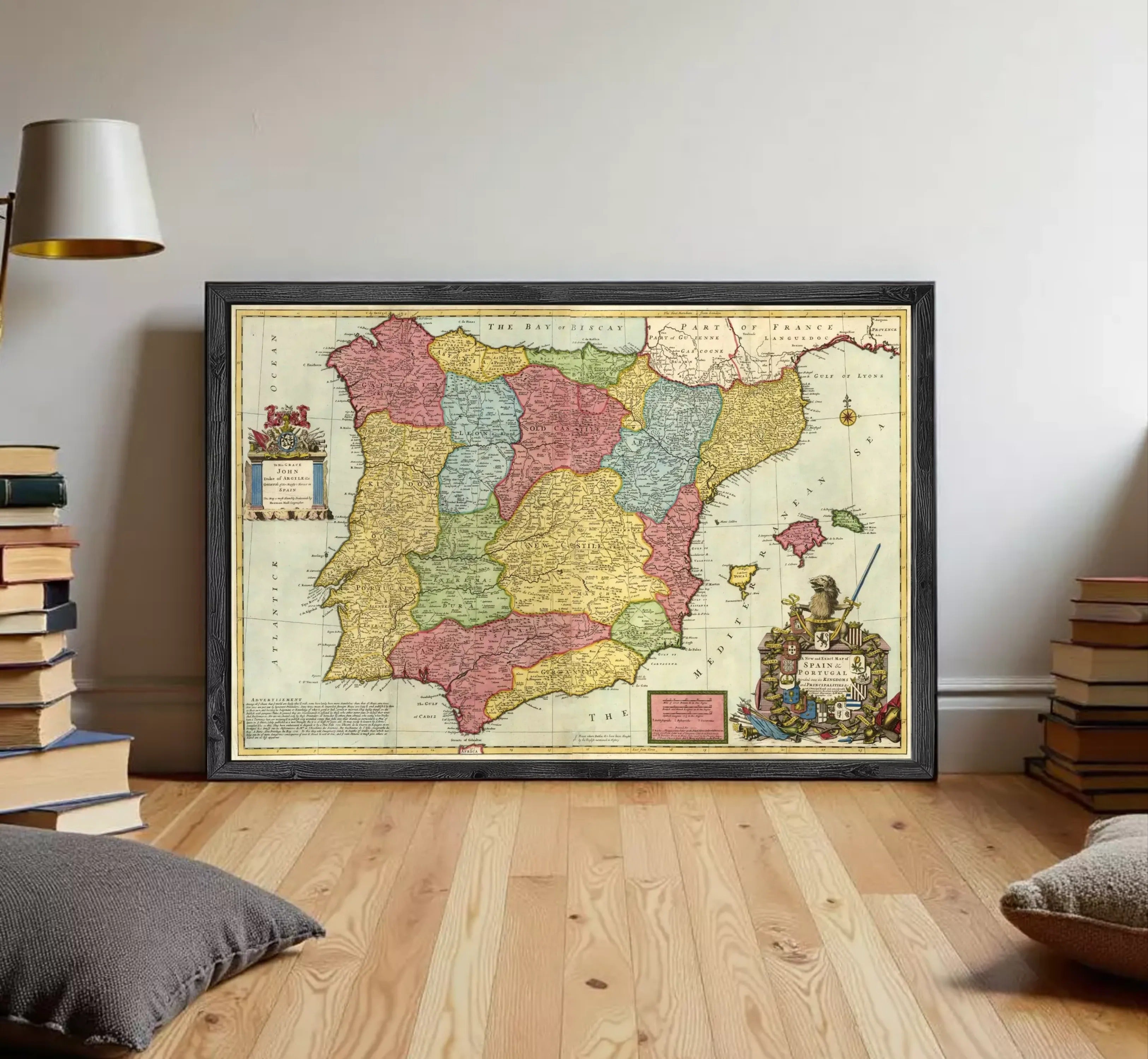 The image is a framed vintage map of Spain, featuring colorful regions and a coat of arms.