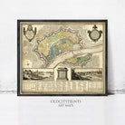 The image is a framed antique map of a city, depicting the layout of the city and surrounding areas.