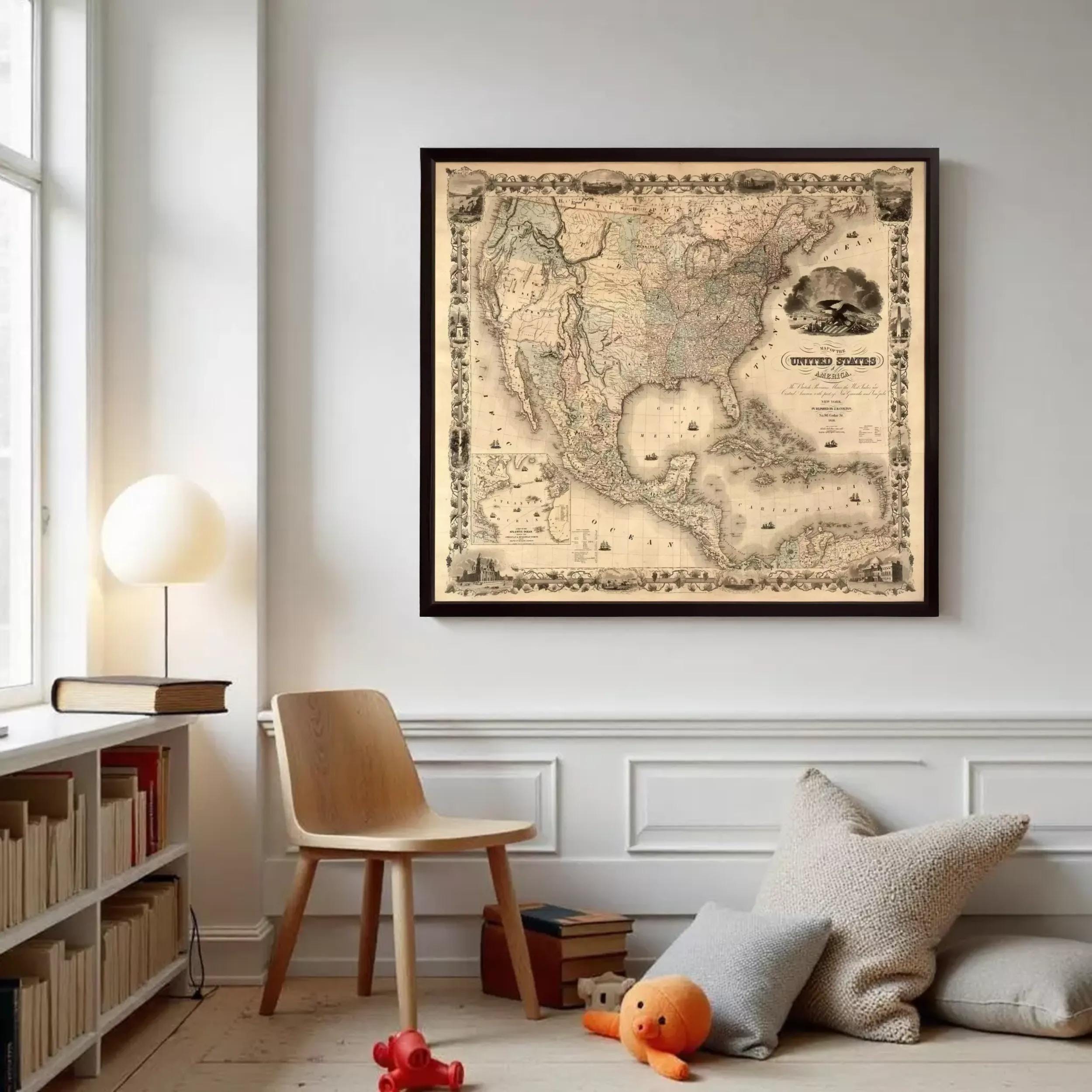 a framed map of the United States hanging on a wall in a room with a wooden chair, a bookshelf, and a stuffed animal.