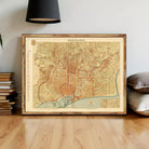 The image is a framed vintage map of Barcelona, Spain, depicting the city's streets and landmarks.