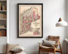 The image is a framed vintage map of New England, depicting the region in a detailed and colorful manner.