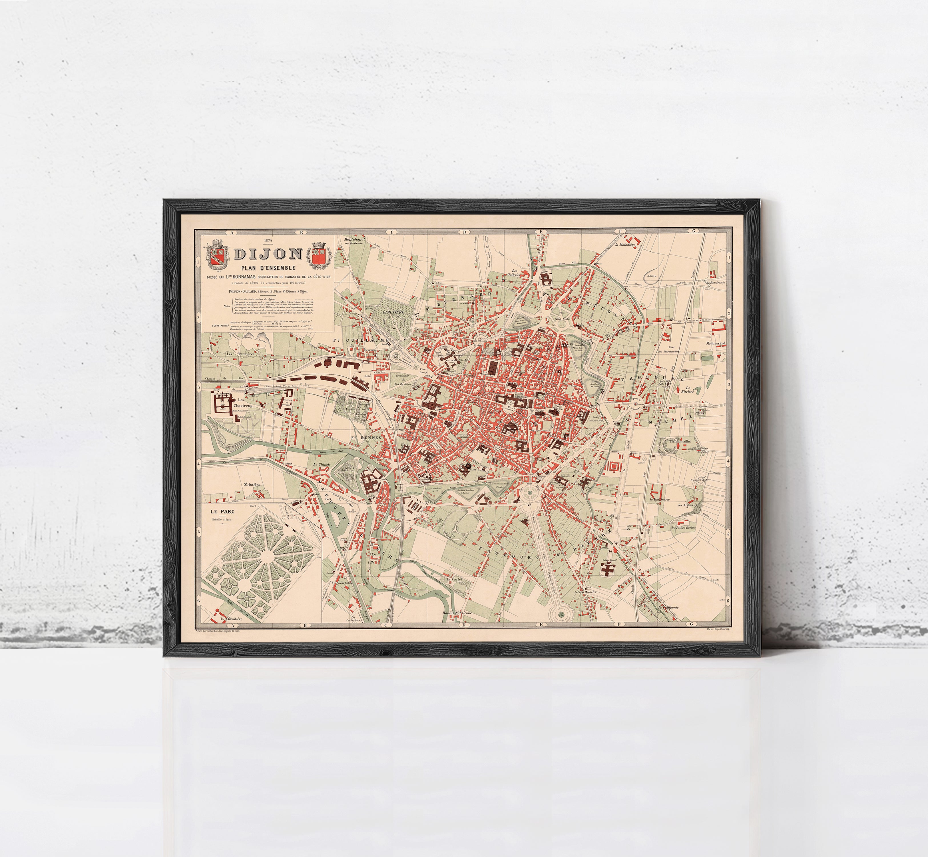 The image is a framed vintage map of a city, likely from the 19th century, with a detailed layout of streets, buildings, and other landmarks.