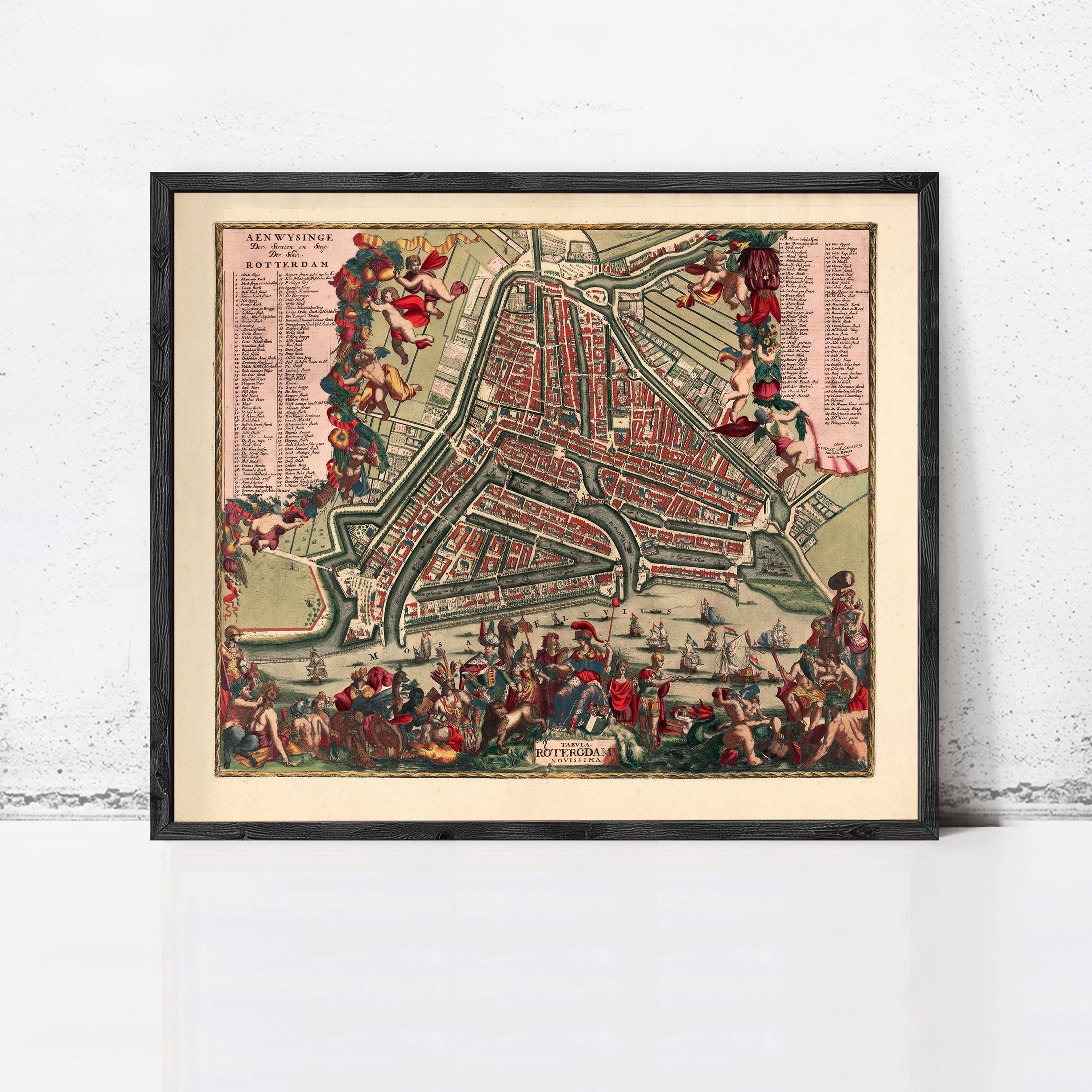 The image is a framed vintage map of Amsterdam, Netherlands, depicting a detailed and colorful representation of the city's streets, canals, and landmarks.
