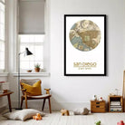 a cozy living room with a large framed map of San Diego hanging on the wall. The room has a comfortable chair, a lamp, and various decorative items, creating a warm and inviting atmosphere.