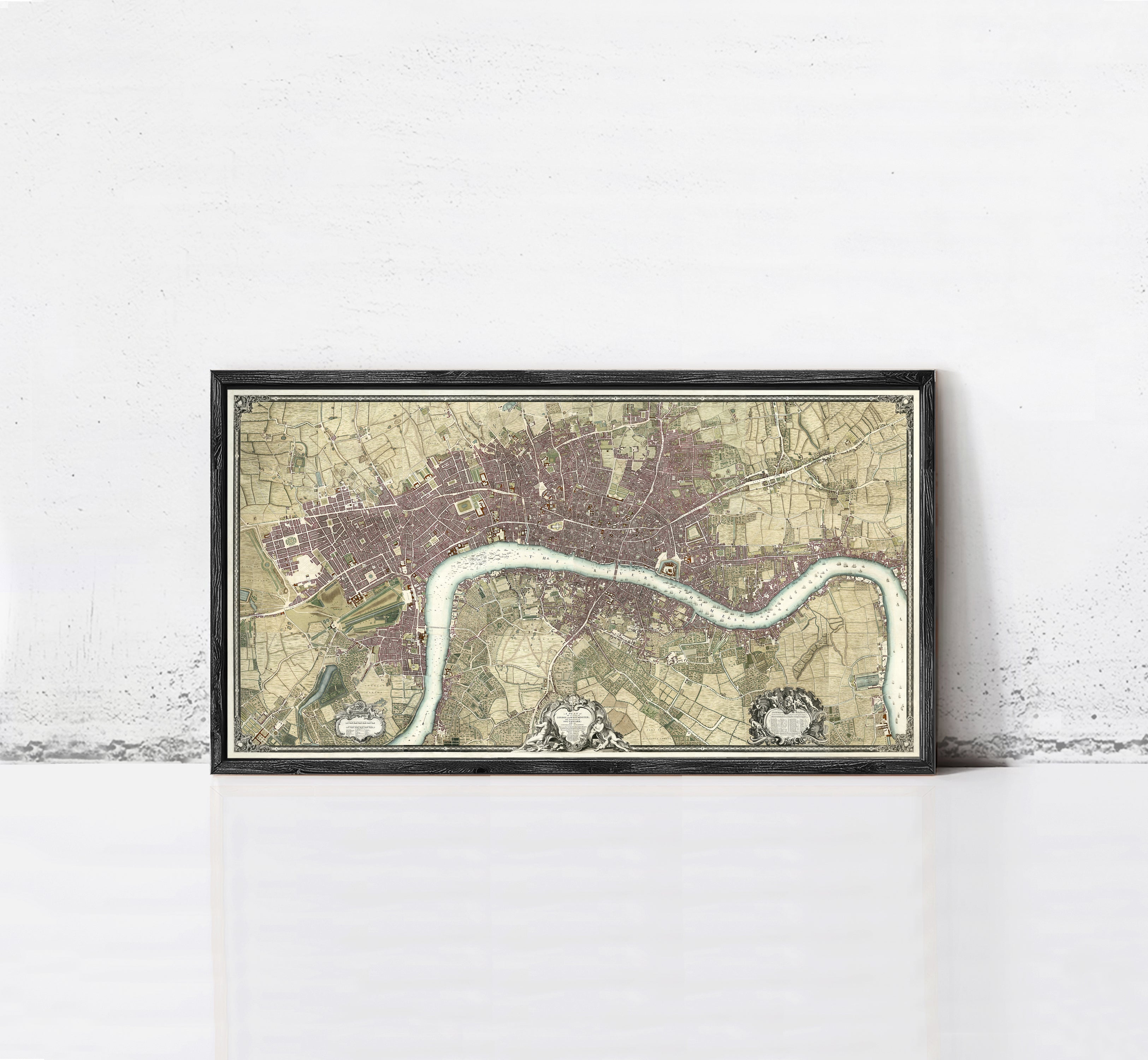 A framed map of London, England, with a river running through the city.