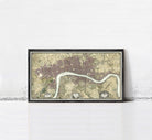 A framed map of London, England, with a river running through the city.