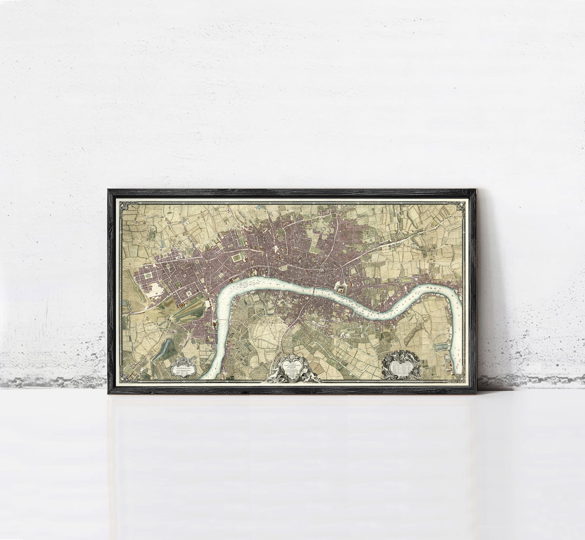 A framed map of London, England, with a river running through the city.