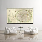 a large framed map of a city displayed on a wall, with two white bean bag chairs positioned in front of it.