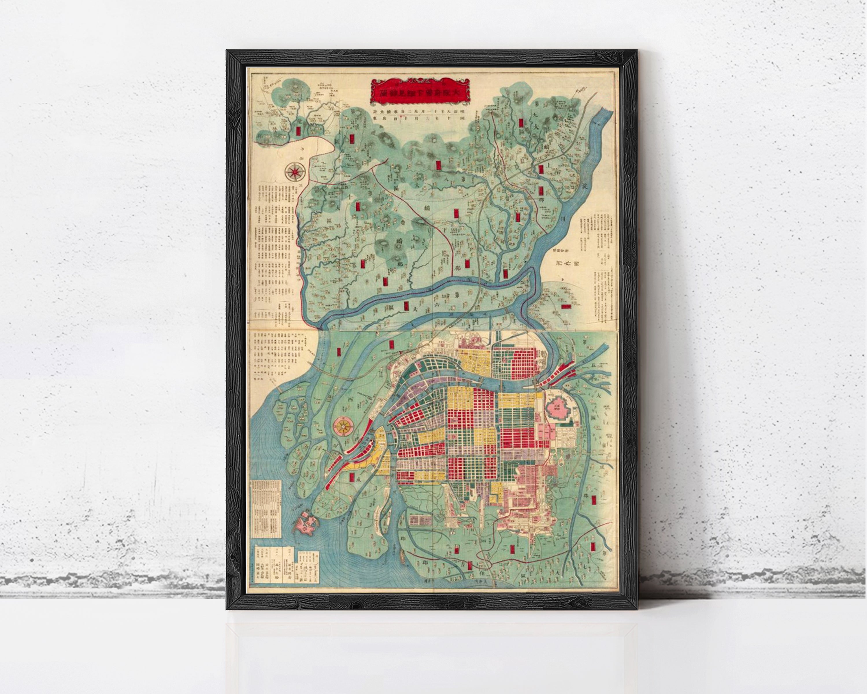 The image is a framed map of a city, likely from the 19th century, with various landmarks and geographical features depicted.