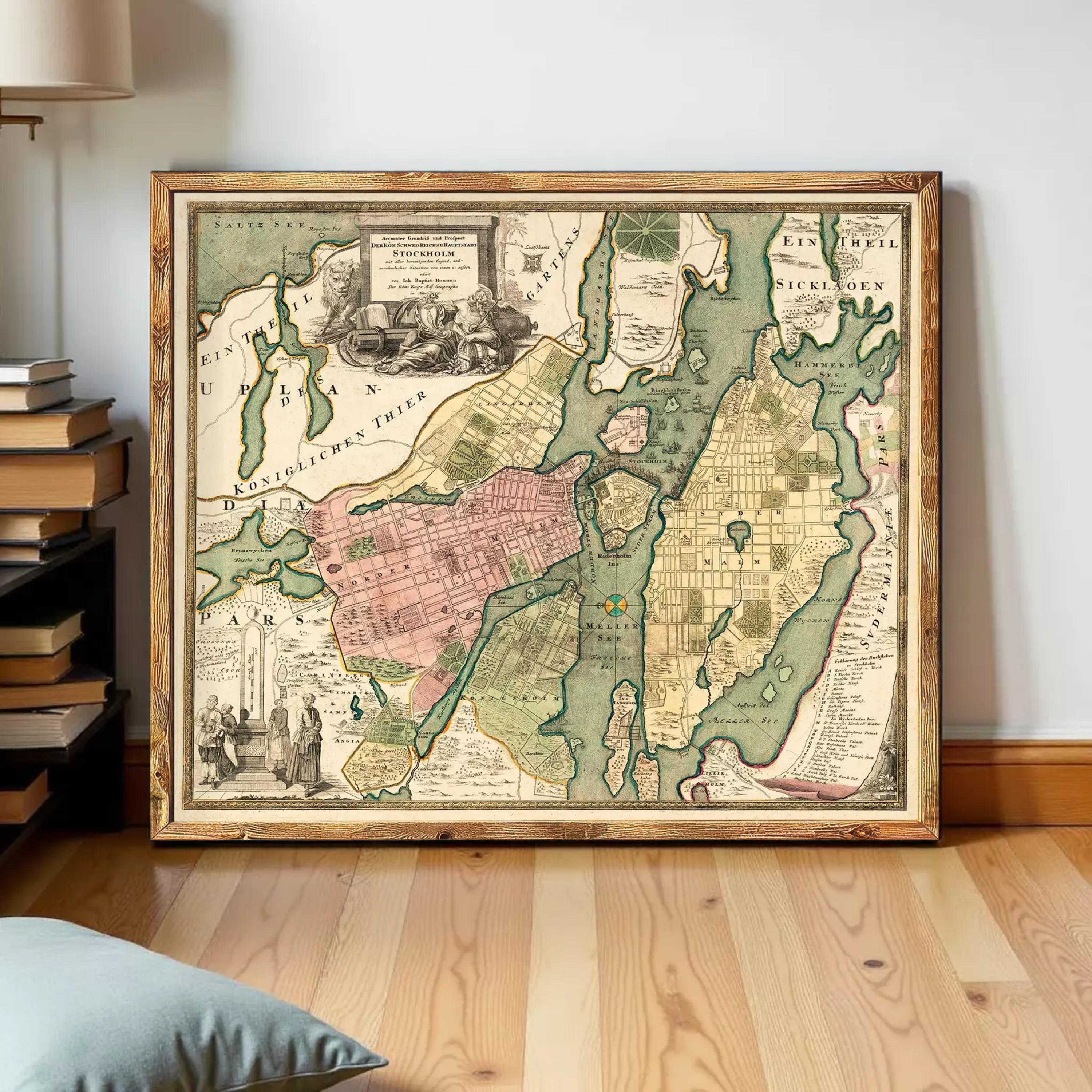 The image is a framed antique map of a city, likely from the 18th century, with detailed cartography and illustrations.