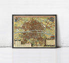 The image is a framed vintage map of a city, likely Paris, with detailed illustrations and labels.