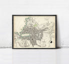 The image is a framed vintage map of a city, likely from the 19th century, depicting the layout and geographical features of the area.