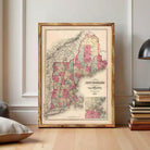 The image is a framed vintage map of New England, depicting the region in a detailed and colorful manner.