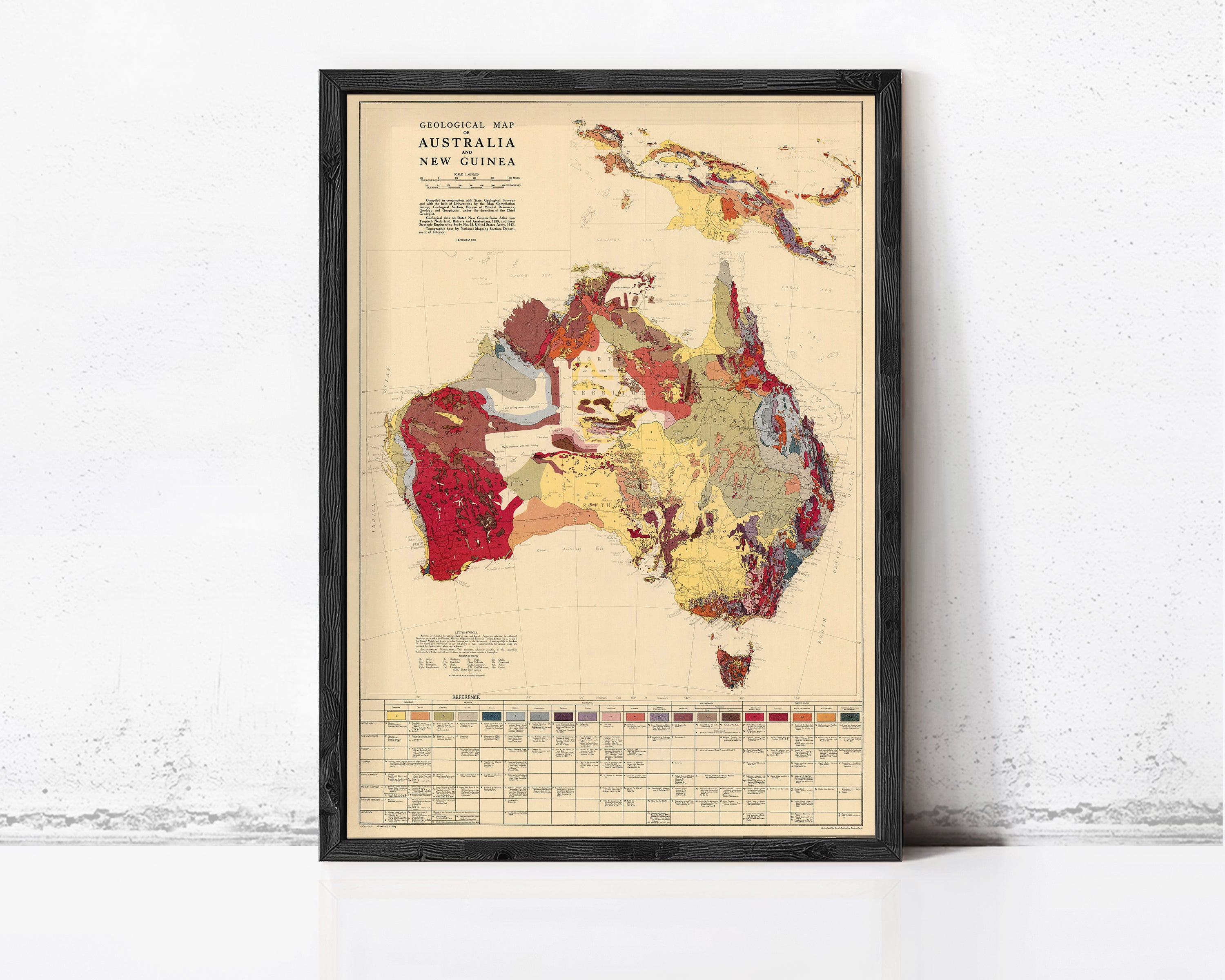 The image is a framed geological map of Australia and New Guinea, depicting the region's geological features and topography.