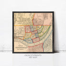 The image is a framed vintage map of Cincinnati, Ohio, depicting the city's streets and neighborhoods in a detailed and colorful manner.