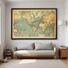 A large framed vintage map of the world is displayed on the wall above a gray sofa in a cozy living room setting.