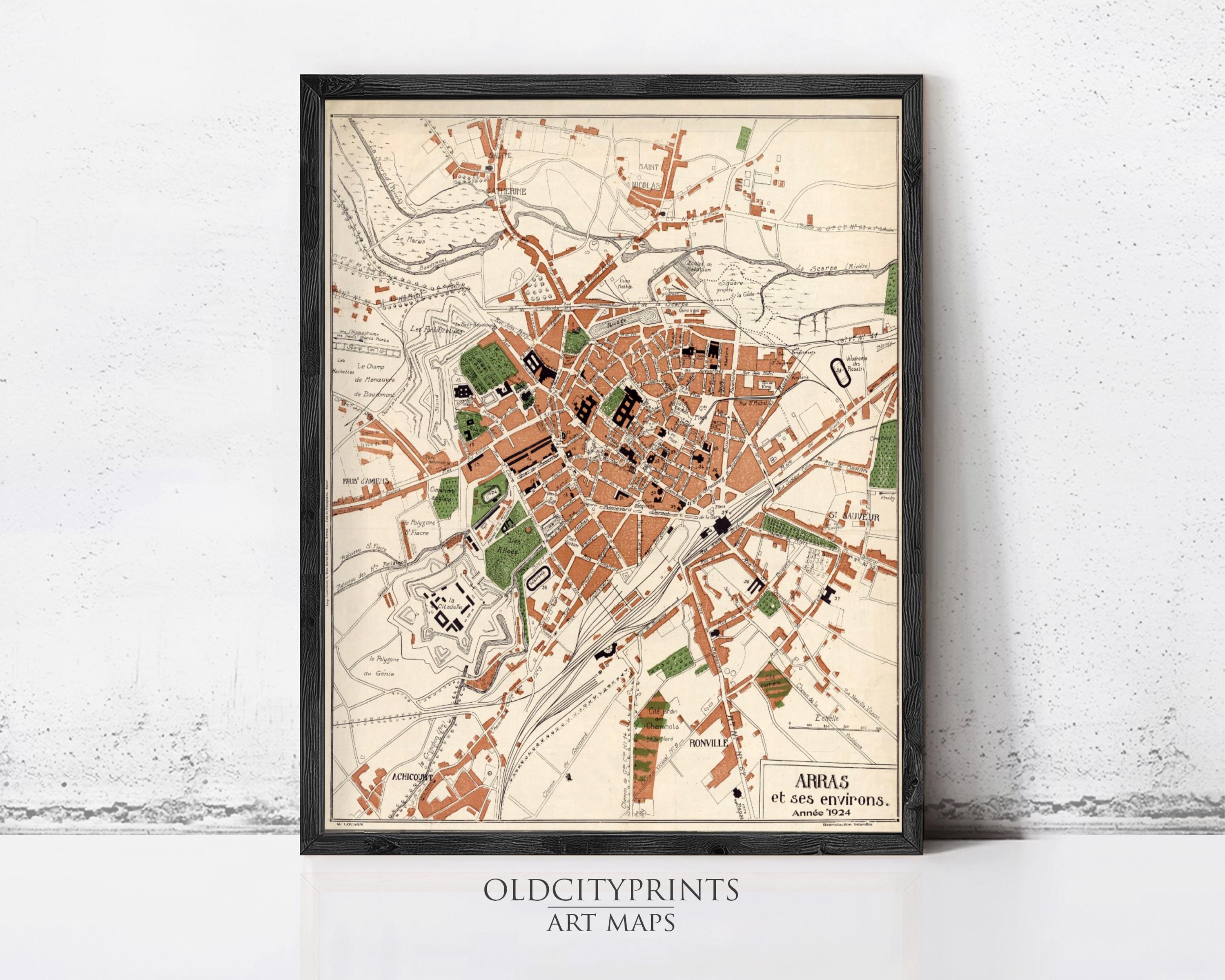 The image is a framed vintage map of a city, likely from the early 20th century, depicting the city's layout and surrounding areas.