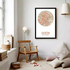 a cozy living room with a wooden chair, a lamp, and a framed map of Gdansk, Poland, hanging on the wall.