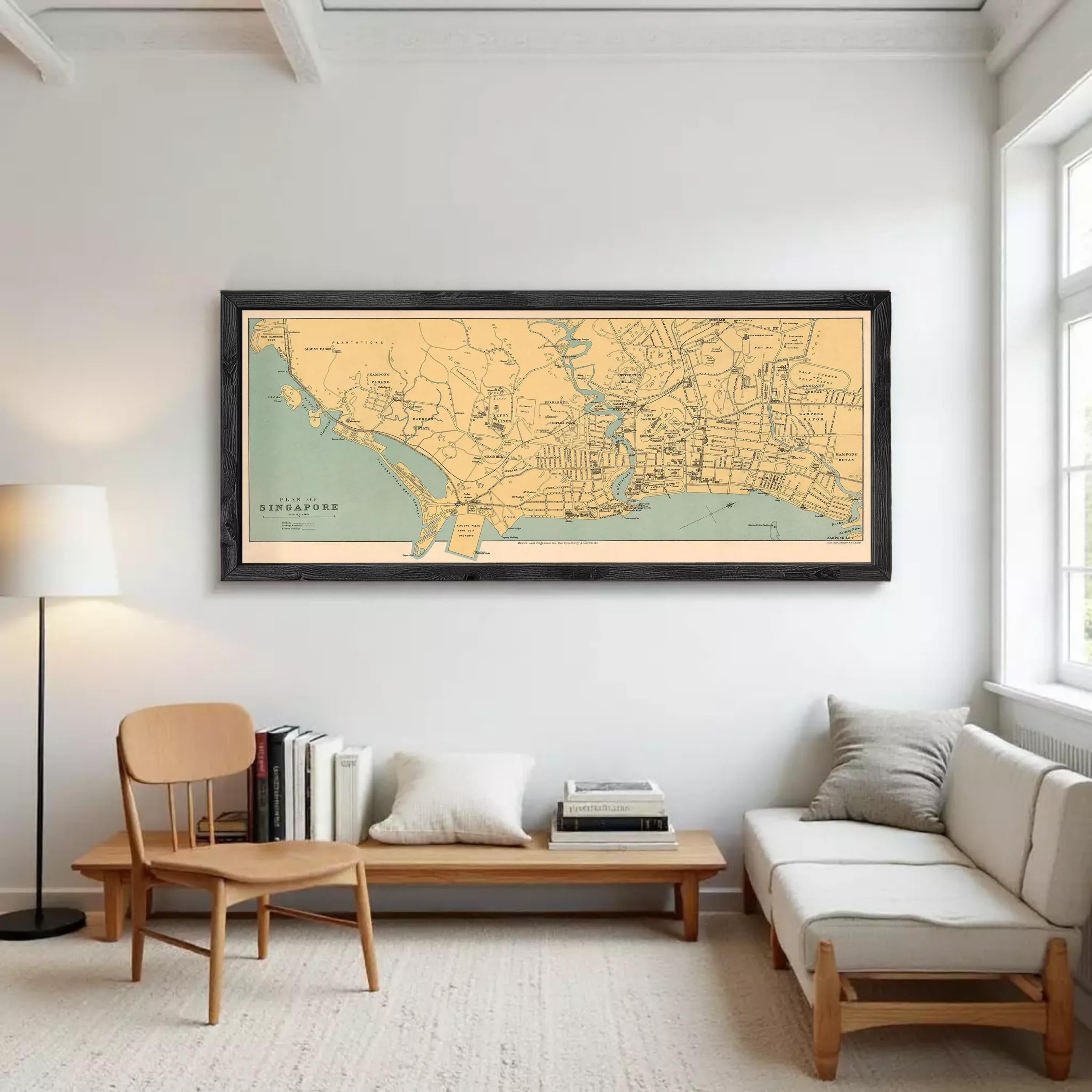 A framed map of Singapore is displayed against a white wall.