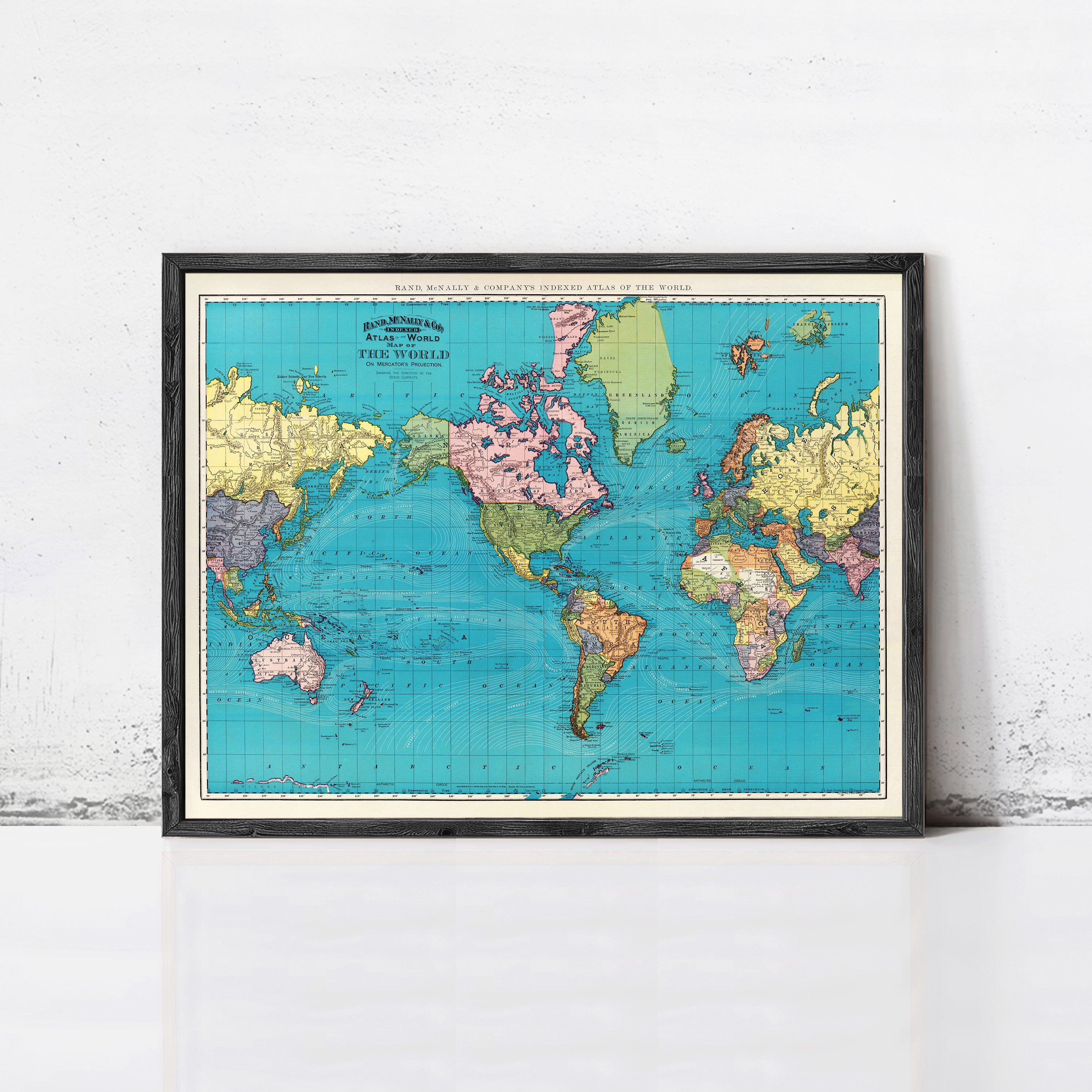 The image is a framed vintage world map with a blue background and colorful country borders.