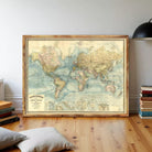 a large, framed world map hanging on a wall in a room.