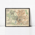 The image is a framed vintage map of a city, depicting various landmarks and streets in a detailed manner.