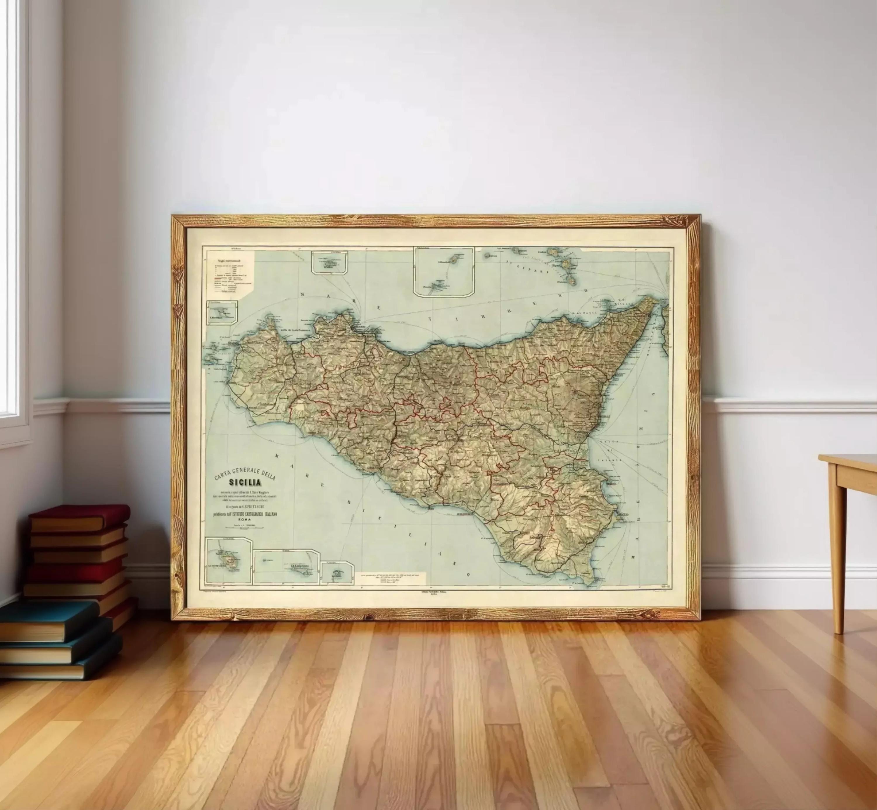 a large framed map of Sicily, Italy, displayed on a wooden floor against a white wall.