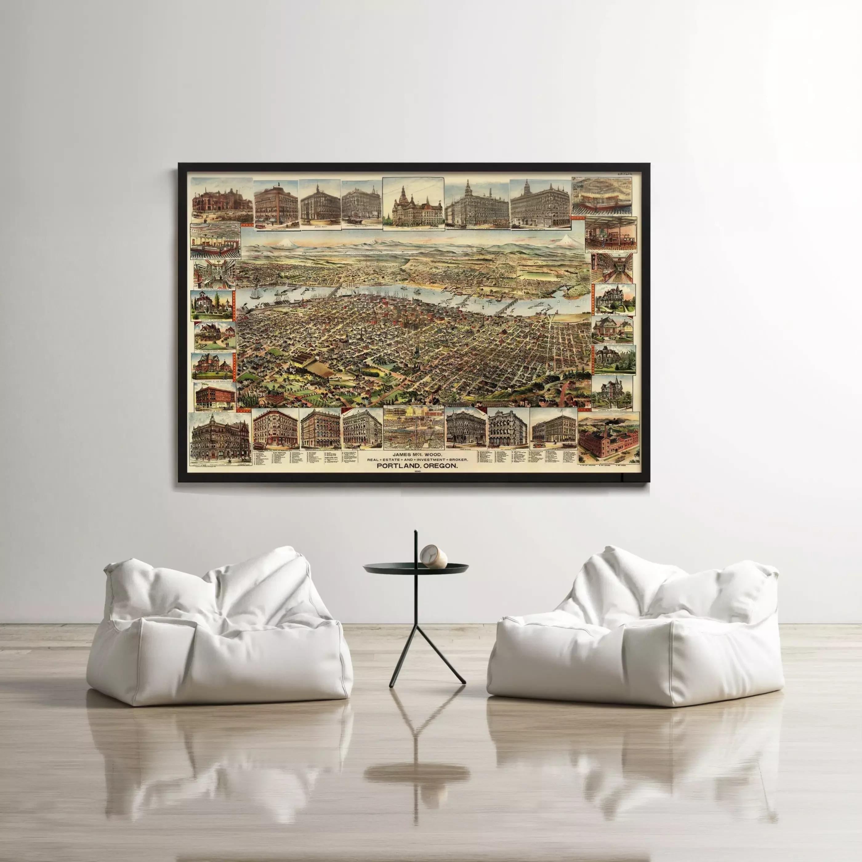 a large framed map of a city hanging on a wall, with two white bean bag chairs positioned in front of it.