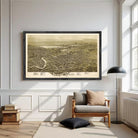a large framed map of a city hanging on a white wall in a living room.